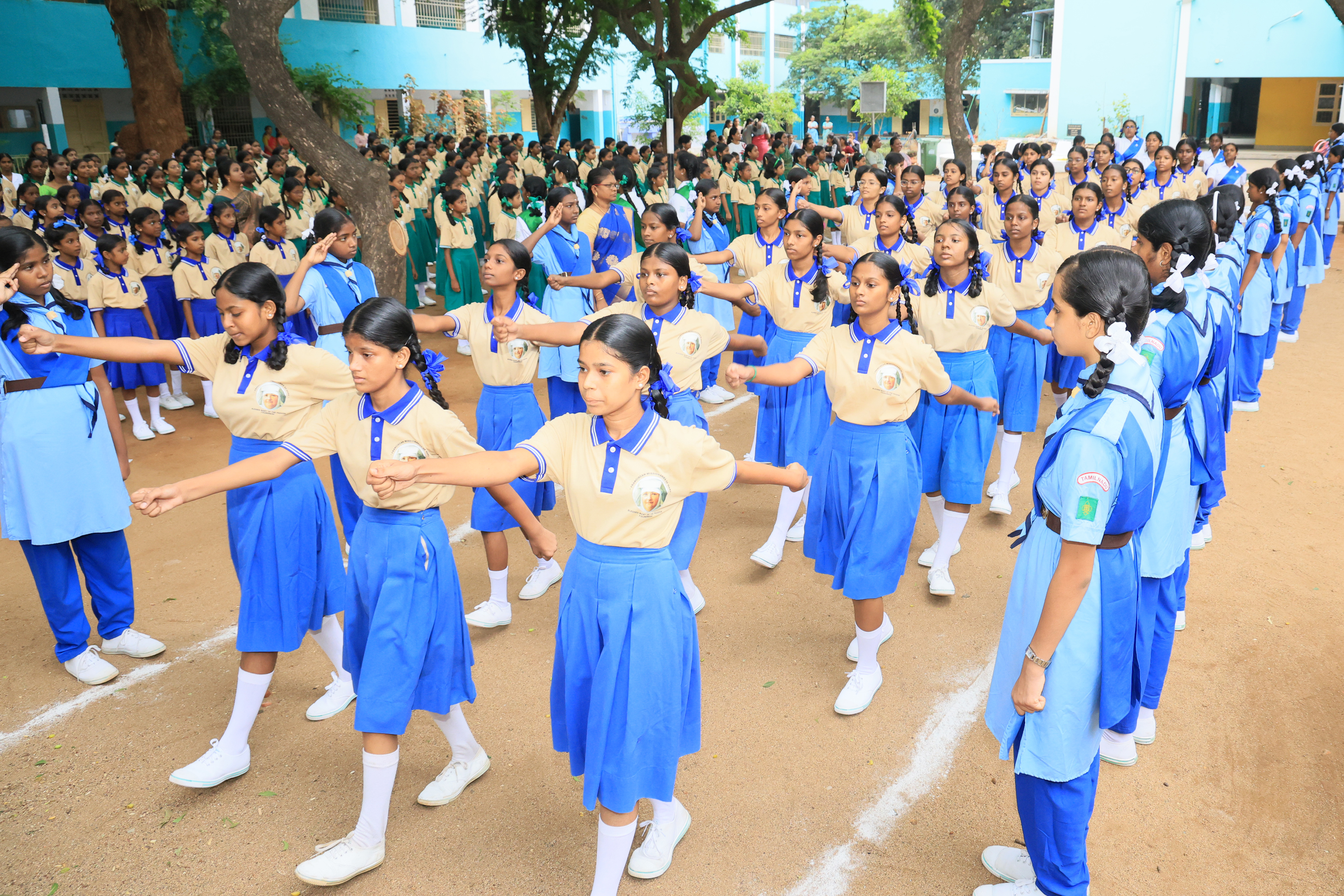 Students in blue uniform marching