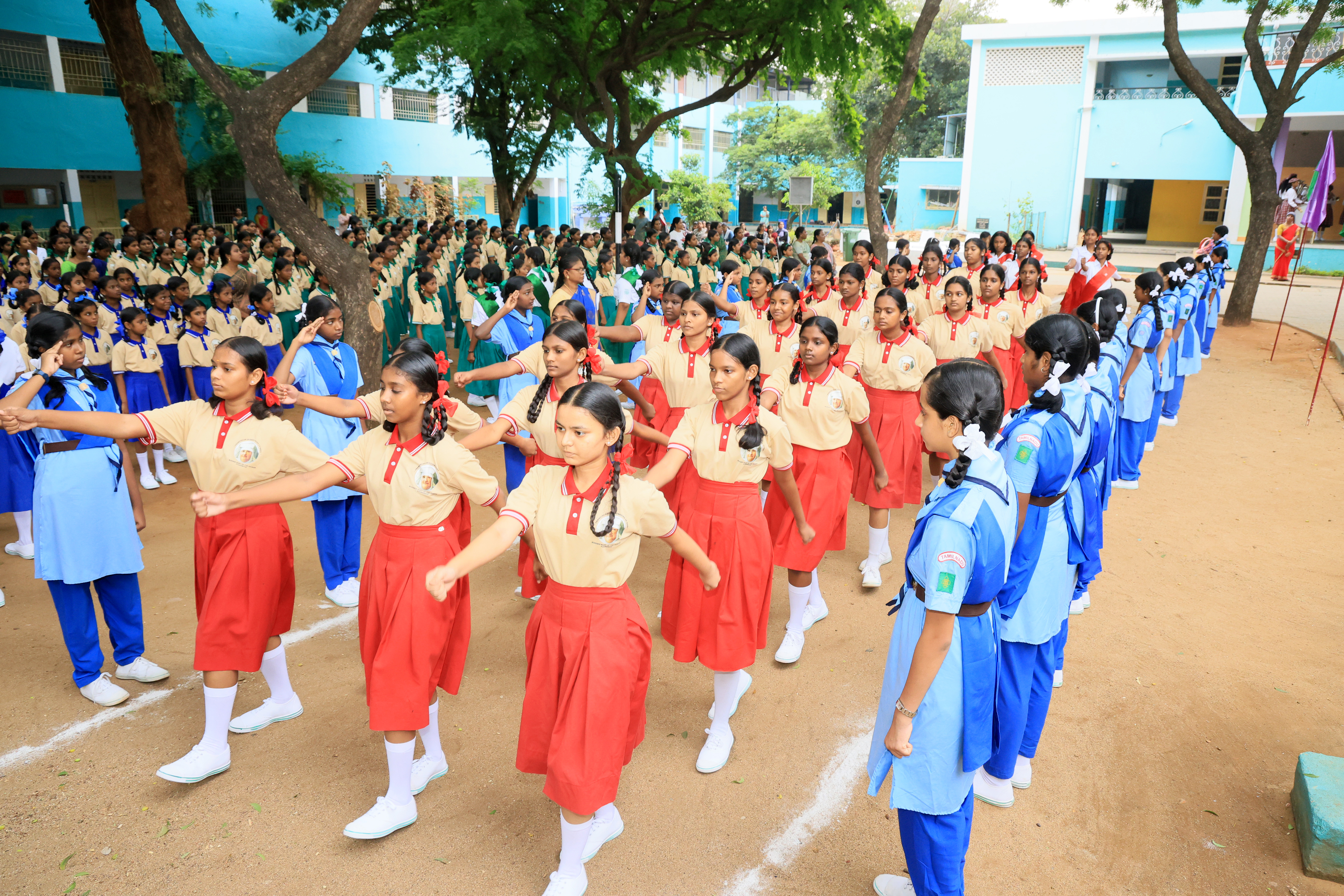 Students in red uniform marching
