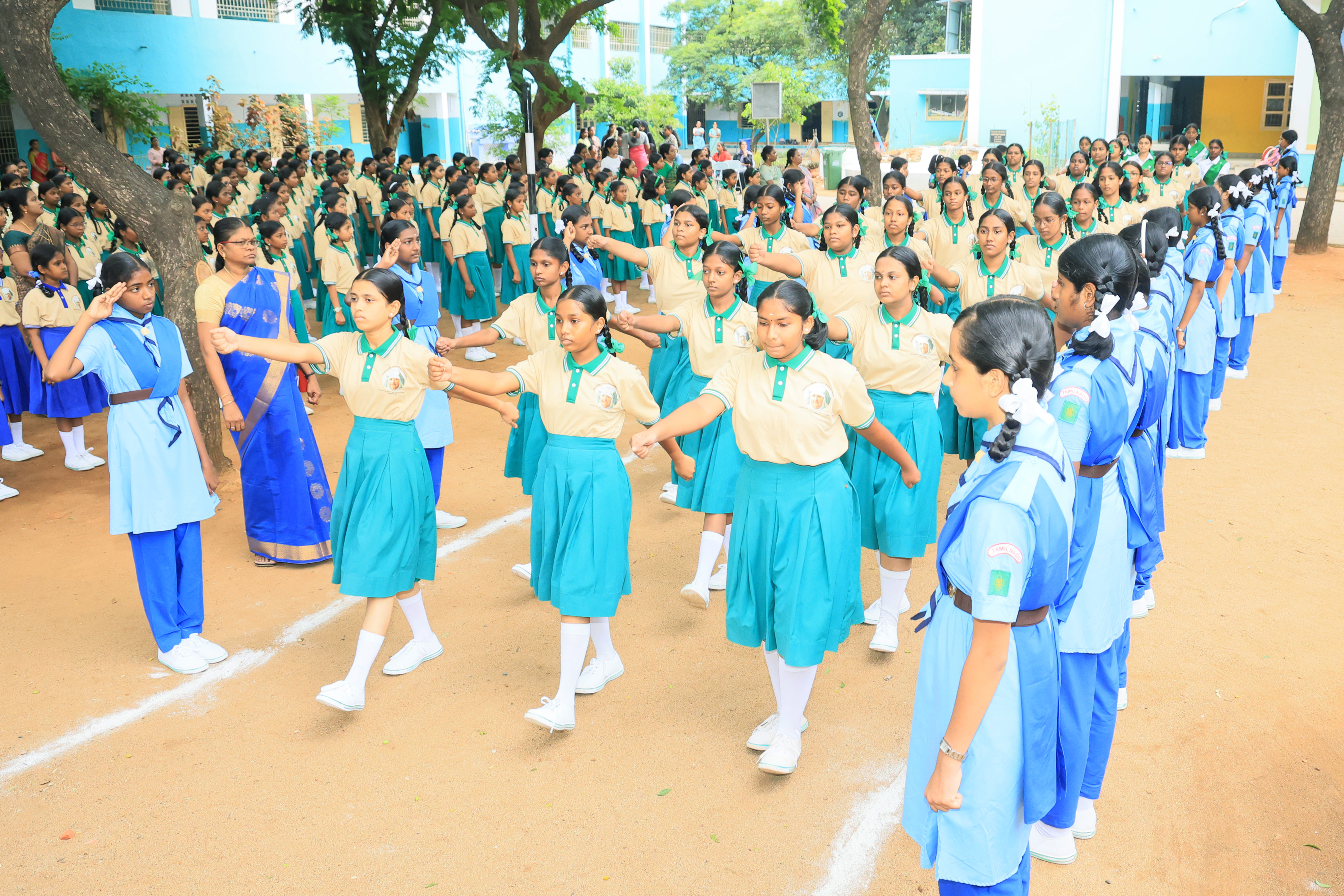 Students in teal uniform marching